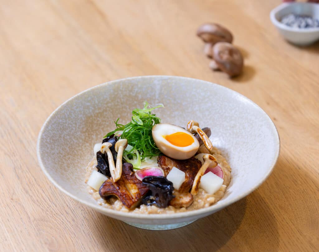 Congee dish with sot boiled egg and mushrooms